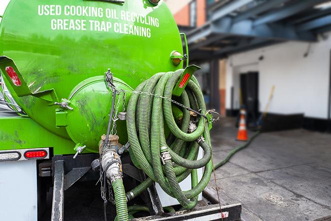 grease trap pumping truck servicing a restaurant in Bentley